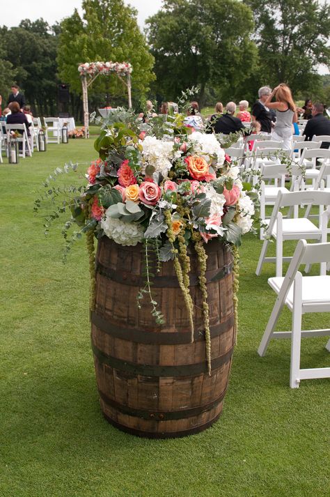 Whisky barrels full of draping flowers. Whisky Barrel Flowers, Barrel Wedding Decor Entrance, Whisky Barrel Wedding Decor, Wine Barrel Flower Arrangements, Wine Barrel Flowers, Whiskey Barrel Flowers, Wine Barrel Wedding Decor, Barrel Wedding Decor, Vinyl Wedding