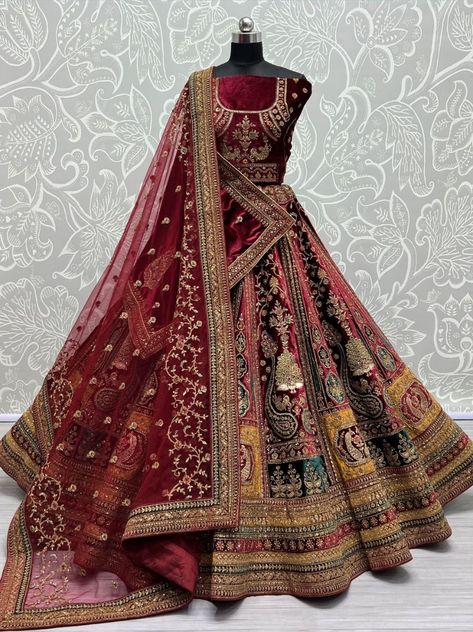 Imagine yourself in this stunning maroon bridal lehenga choli, adorned with breathtaking sequins and intricate embroidery work. This exquisite ensemble is made from luxurious heavy velvet, ensuring a regal and elegant look on your special day. The lehenga features a charming peacock figure and fancy dori work, designed to captivate attention wherever you go. To further enhance its allure, the set includes two dupattas. The first one is crafted from velvet and embellished with four-sided adornmen Bridal Lehenga Maroon, Maroon Bridal Lehenga, Double Dupatta, Red Wedding Lehenga, Velvet Lehenga Choli, Latest Bridal Lehenga Designs, Chic Prom Dresses, Pakistan Wedding, Bridal Lehenga Designs