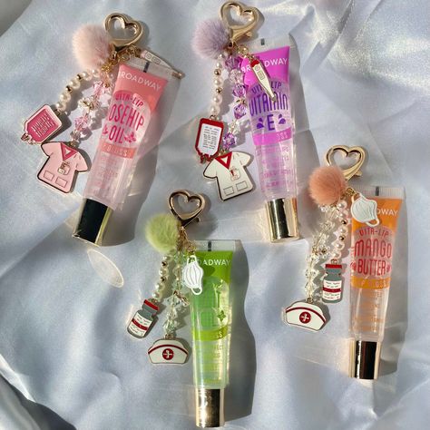 These keychains are a great way to accessorize while keeping lip gloss handy at all times!  * Nursing & healthcare inspired charms * Gold metals with pearl accents Various colors available! Lip Gloss With Charms, Lip Gloss Charms, Keychain Lipgloss, Lip Gloss Keychain, Lipgloss Keychain, Lip Balm Keychain, Charm Necklace Diy, Nursing Fun, Diy Lip Gloss