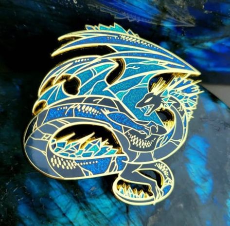 Back in stock! And with updated colors to make this dragon even more beautiful from the last!  Labradorite Dragon Pin - Hard Enamel - 55mm (2.2in) - Metal Butterfly Clasps - Gold Plating - Glitter accents We thank the backers of the Kickstarter to make these pins go from being a dream to a reality. These Pins make for great center pieces thanks to their size and with the variety of Dragon pins we have on the shop, we hope for everyone to find one that speaks to them. 17 designs are purely original, while 4 are inspired off of video games. With the launch of these pins we hope to make more in the future. Check out the Kickstarter! https://www.kickstarter.com/projects/spectroliteaaa/dragon-enamel-pins-the-four-seasons This pin is apart of the Crystal Enamel Pin Set! These pins are inspired b Dragon Hoard, Ewolucje Eevee, Enamel Pin Collection, Metal Butterfly, Pretty Pins, Cool Pins, Center Pieces, Rocks And Gems, Hard Enamel Pin