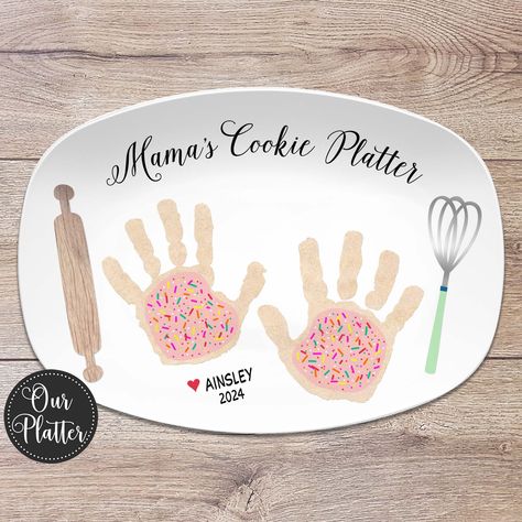 "Give a thoughtful, personalized gift featuring your own children's handprints as cookies for the thoughtful baker. This is a one of a kind special gift perfect for Mother's Day, Father's Day or other special occasion. Our 10x14\" platters are beautiful serving pieces made of a quality, durable plastic resin that is BPA-free. Dishwasher and microwave-safe.   - - - - - - - - - - - - - - - - - - - - - - - - - - - - - - - - - - -  15% OFF - MULTIPLE ORDER DISCOUNT - - - - - - - - - - - - - - - - - Handprint Cookie Plate, Handprint Platter Grandparents, Diy Mother’s Day Plates, Handprint Cookies For Santa Plate, Baby Gifts To Grandparents, Family Handprint Craft, Toddler Gift To Parents Christmas, Christmas Gift For Grandma From Baby, Mothers Day Plates Ideas