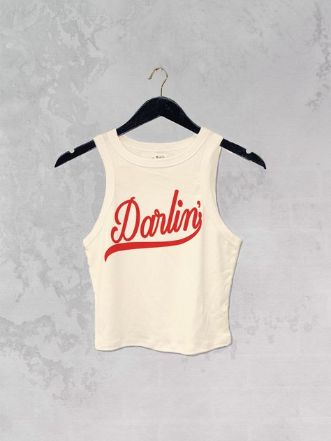 Get all of the southwestern vibes in this Darlin' western inspired retro 90's style cropped tank! - Features the phrase " Darlin' " in a red ink - Screen print transfer that is heat pressed onto each tshirt - Tshirt is a super soft, 90s style micro ribbed baby tee - Regular Baby Tee Fit - Cotton / Poly Blend *due to screens and filters colors may vary slightly to photos* 90s Tshirt, Cowgirl Baby, Western Clothes, Bachelorette Ideas, Nashville Style, Nashville Trip, Turtle Tattoo, Print Transfer, Country Fashion