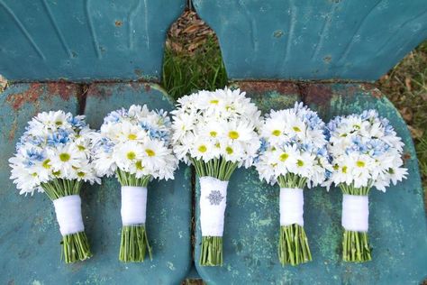 5. Daisy For a cheery springtime bouquet, white daisies are a great go-to—whether they're being used as a filler flower or making up the entire arrangement. They naturally grow white blossoms, but thanks to food coloring they can be tinted purple, blue, neon green... almost any color under the rainbow.  blooming season: late spring White Daisy Wedding Bouquet, Daisy Bouquet Wedding, Budget Wedding Flowers, Inexpensive Wedding Flowers, White Flower Arrangements, Cheap Wedding Flowers, Daisy Wedding, Daisy Bouquet, Spring Wedding Flowers