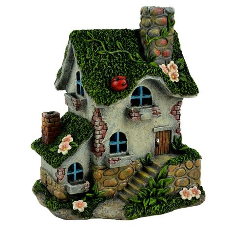 "We finally have this popular solar fairy house in stock!  It is made of resin.  The cottage has a German schmear finish, which exposes some brick.  Plants and greenery are on the side of the stairs that lead up to a brown door.  The door does not open.  Three blue paned windows with flower boxes are on the front of the house as well as  on each side.  The roof is covered with textured green moss and adorned with flowers and a ladybug.  The solar cell  on the back of the roof will create a glow Cottage House, Fairy House, Fairy Garden, Solar, Miniatures, Cottage, Plants, Flowers