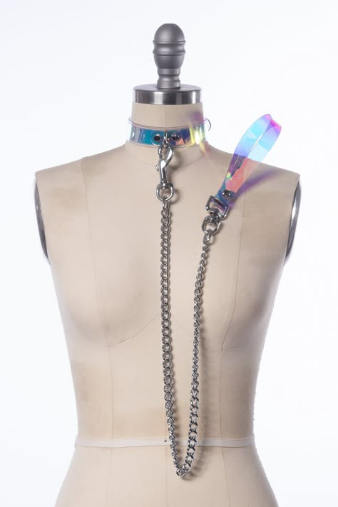 "Magical, color-shifting iridescent choker collar made in thick PVC. Holographic, iridescent vinyl is layered over clear PVC.  Features a d-ring in center front. Fit is adjustable with buckle in back.   The leash clips on to the d-ring. The heavy-duty chain is 30\" long, total length including the handle is 36\" long. Collar is 1\" wide. Silver toned hardware.  SMALL/MEDIUM (11-13\") MEDIUM/LARGE (13-15\") LARGE/X-LARGE (15-17\") Custom sizing available.   Please allow 1-2 weeks for construction Holographic Iridescent, Gothic Choker, Mode Kawaii, Pet Spaces, Gothic Chokers, Stunning Tops, Choker Collar, Leather Pieces, Pastel Aesthetic