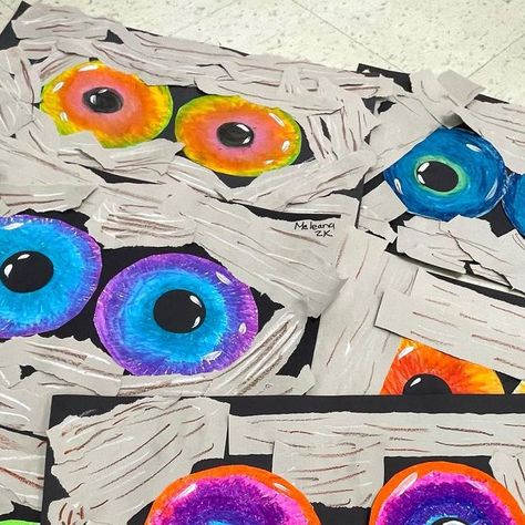 Ashley H on Instagram: "Analogous Mummy Eyes 👀 2nd graders lived this one. Oil pastel eyes, collaged grey paper strips on top! 2 day project! They look great hanging over their lockers! Collaboration with my team teacher @art_with_mrs.kay #artprojectsforkids #elementaryart" Mummy Eyes Art, Eyes Craft, Teacher Art, Grey Paper, Halloween Paper Crafts, October Crafts, Craft Club, Halloween Paper, Fall Kids