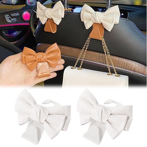 PRICES MAY VARY. 🎀【Add Style to Your Car】These cute car seat headrest hooks are designed to add a touch of fashion to your car's interior design, making it look more stylish and trendy. 🎀【Sturdy and Durable】Made from high-quality ABS construction, these hooks are sturdy and durable, ensuring a long-lasting use. They can hold up your purses, bags, and other items securely without any worry of them falling off. 🎀【Portable and Space-Saving】These hooks are portable and lightweight, making them ea Cute Phone Holder For Car, Neutral Car Accessories, Tan Car Interior Decor, Cute Car Essentials, Car Accessories Western, Car Accessories For Girls Interior, Cute Cars Accessories, Rose Gold Car, Car Hooks