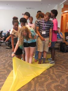 Team Building Activity: Beach Towel Flip | GUIDE, Inc. Kids Team Building Activities, College Track, Permainan Kerjasama Tim, Leadership Games, Steam Lab, Building Games For Kids, Fun Team Building Activities, Team Building Activity, Cousin Camp