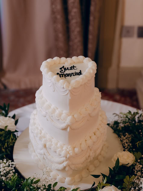 Celebrate your special day with this elegant wedding cake adorned with intricate piping and a charming "Just Married" topper. Surrounded by lush greenery and delicate flowers, this cake adds a touch of classic romance to your wedding reception. #WeddingCake #JustMarried #ElegantDessert #ClassicRomance #WeddingReception #WeddingInspiration #SweetCelebration #BridalDetails White Piping Wedding Cake, Wedding Cake White Piping, Wedding Cake No Fondant, Small Two Tier Wedding Cake, Wedding Cakes Elegant Unique Classy, Simple 3 Tier Wedding Cake, 3 Layer Wedding Cake, Two Wedding Cakes, Top Tier Wedding Cake