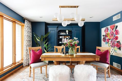 Steer clear of “sad beige,” and opt instead for jewel-toned selections like Twigg + Lu Design Co. did inside this remodeled dining room, which is drenched in a deep blue hue with pops of pretty pink. Itching to make it your own? Ponder plum, emerald, navy, or magenta to cash in on this colorful concept. See more colorful ideas to steal at the link here. 📸: Kendra Denault Pops Of Color Dining Room, Jewel Toned Dining Room, Jewel Tone Home Decor Inspiration, Jewel Tone Dining Room, Jewel Tones Interior Design, Bold Dining Room, Colorful Transitional, Jewel Tone Living Room, Colorful Dining Room