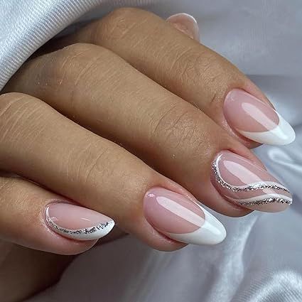 Hey there, gorgeous! 😍 Get your hands on our sassy French Tip Press On Nails. 🇫🇷💅 Rock that cute and classy look with these Almond White Fake Nails featuring Silver Curve Glue Ons. 💎 Ideal for all the lovely ladies out there, they're just perfect for any occasion - be it weddings or birthdays. 🎉 No need for acrylic gel, just stick 'em on and you're good to go! 🚀