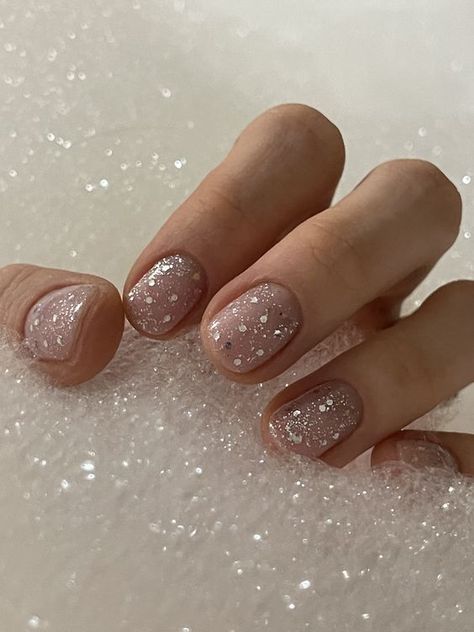 15 Short Winter Nail Ideas for 2023-2024 - thepinkgoose.com Glitter Wedding Nails Short, New Year Nails Short Simple, Big Sparkle Nails, Glitter At Base Of Nail, Small Winter Nails, Short Glitter Nails Sparkle, Short Sparkly Nails Acrylic, Clear Nails With Silver Glitter, Natural Festive Nails