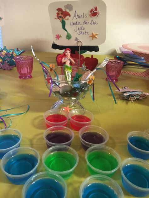 jello-shots with Titos Vodka and some with Smirnoff Whipped Cream Vodka. Red for her hair, purple for her shells, green for her tail and blue for the ocean. My adult Disney Princess 40th Birthday Party. Disney Theme 30th Birthday, Disney Themed 21st Birthday Party Ideas, Disney Princess Party For Adults, Disney 18th Birthday Party, Disney Themed 30th Birthday Party, Disney 30th Birthday Party, Disney Birthday Party For Adults, Disney 21st Birthday Ideas, Disney Party For Adults