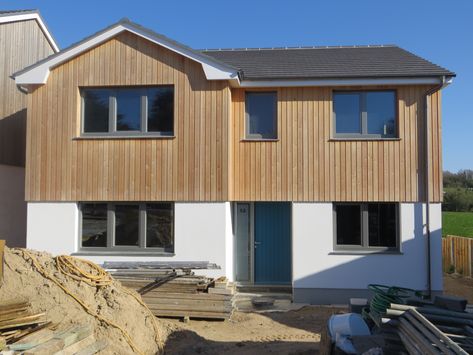 Siberian Larch Cladding, 4/5 Bed New Build in Rock, Cornwall. Cladding Front Of House, Half Cladded House, External Cladding Ideas House Exteriors, Larch Cladding Exterior, House Cladding Ideas, Cedar Cladding House, Render And Cladding, Cladding House Exterior, Exterior Cladding Ideas