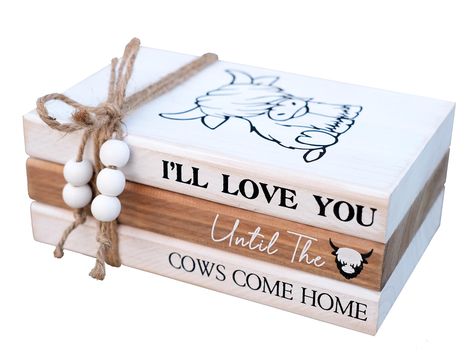 PRICES MAY VARY. 【HANDCRAFTED WOOD BOOK STACK】This farmhouse stacked books decor consists of 3 books made of solid cedarwood. White and brown painted with slight distressing finish. Cute "cattle" printed on top book face, while books' spine has warm inspirational quote "I'll Love You Until the Cows Come Home". 3 farmhouse wood books glued together, won't move to get loose, bookstack bound with rustic twine,the hemp rope's ends are threaded with wood beads. 【HIGHTLAND COW DECOR】This farmhouse ins Hyland Cow Decor, Stacked Books Decor Diy Wood, Rustic Farmhouse Living Room Decor Farm Houses Country Style, Stacked Books Decor Diy, Book Stacks Decor, Wood Book Stacks, Projects With Wood, Farmhouse Shelf Decor, Cow Crafts