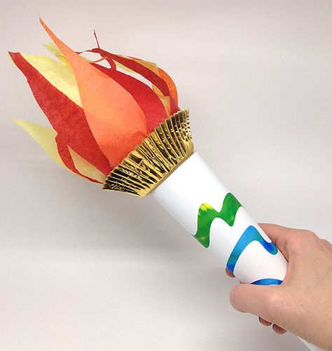 Hand holding a finished paper torch. Diy Torch, Torch Craft, Olympic Torch Craft, Vbs Olympics, Preschool Olympics, Olympic Games For Kids, Olympic Theme Party, Olympic Idea, Kids Olympics