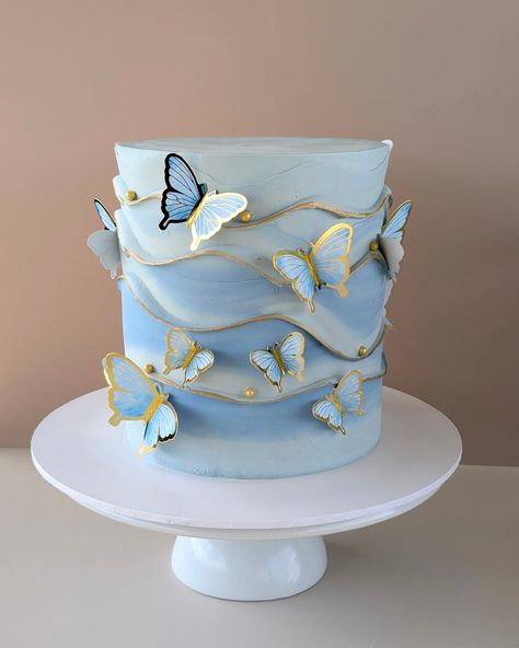 🦋 Enchanting Butterflies in Blue 🦋 This delicate, dreamy cake features hand-crafted details and a soft ombré blue finish, adorned with fluttering butterflies and touches of gold for a touch of elegance. Perfect for those special celebrations where beauty and taste come together in perfect harmony. #butterflycake #wavecake #SwissMeringueButtercream #penritheats #penrithcakes #acdnmember Elegant Butterfly Cake, Blue Butterfly Cake, Blue And Gold Cake, Dreamy Cake, Wave Cake, Fluttering Butterflies, Butterfly Cake, Swiss Meringue Buttercream, Butterfly Cakes