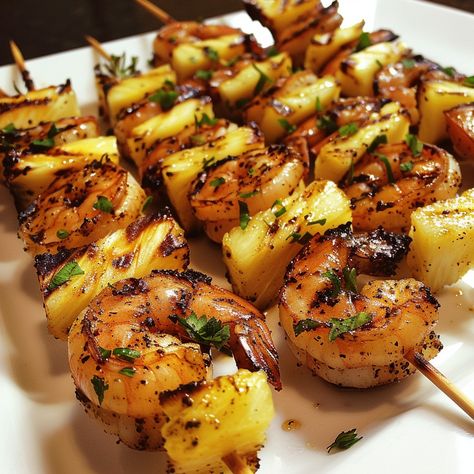 Grilled Jerk Shrimp and Pineapple Skewers 🍤🍍 Experience the perfect blend of spicy and sweet with these Grilled Jerk Shrimp and Pineapple Skewers. This dish is ideal for a summer barbecue or a flavorful dinner. Ingredients: 1 lb large shrimp, peeled and deveined 2 cups fresh pineapple chunks 3 tablespoons jerk seasoning 2 tablespoons olive oil 2 tablespoons lime juice 1 tablespoon honey Fresh parsley or cilantro, chopped for garnish Wooden or metal skewers Preparation: Prepare the Marinade: ... Jumbo Shrimp Skewers, Chicken And Shrimp Skewers, Grilled Jerk Shrimp, Shrimp And Pineapple Skewers, Skewers On The Grill, Shrimp And Pineapple, Grilled Skewers, Pineapple Skewers, Cooking Goals