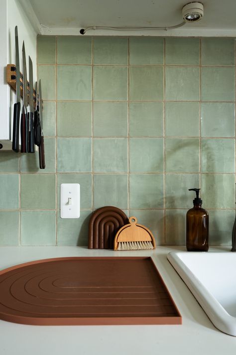 Kitchen with green square tile and white countertops Green Zellige Tile Kitchen Backsplash, Green Vertical Tile Backsplash, Green Tile White Cabinets, White And Green Tiles Kitchen, Pale Green Kitchen Backsplash, Green Tile Countertop, Tile Over Countertops, Green Square Tiles Kitchen, Green Square Backsplash