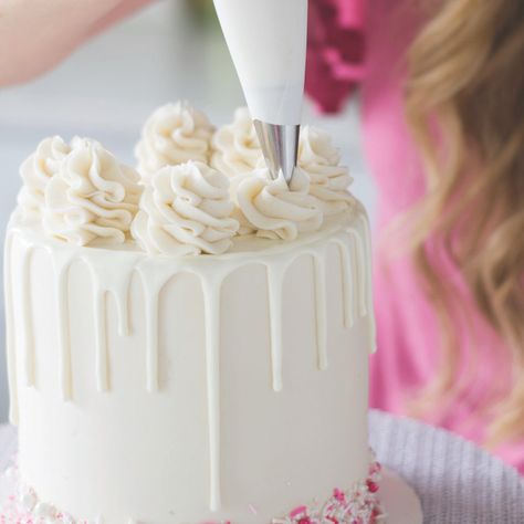 So This Is How You Decorate a Cake Like a Pro | Brit + Co Perfect Drip Cake, Candy Melt Drip Cake, Rosette Drip Cake, Icing Swirls On Cake, How To Make Swirls On Cake, How To Make A Drip Cake Step By Step, Drip Icing Recipes Easy, Candy Melt Drip Recipe, How To Make A Drip Cake