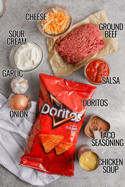 Layered Dorito Casserole is an easy family favorite recipe! Lean ground beef is seasoned with taco seasoning and salsa to create a delicious filling. Layers of Doritos create a delicious casserole which is then topped with our favorite taco-inspired toppings! #layereddoritoscasserole #doritocasserole #tacocasserolewithdoritos #spendwithpennies Casserole Recipes Doritos, Dorito Bake Casserole, Nachos Recipe Doritos, Dorito Meals, Ground Beef And Doritos Recipes, Dorito Taco Casserole Bake, Easy Dorito Casserole Hamburger, Dorito Casserole Recipes, Taco Bake With Doritos