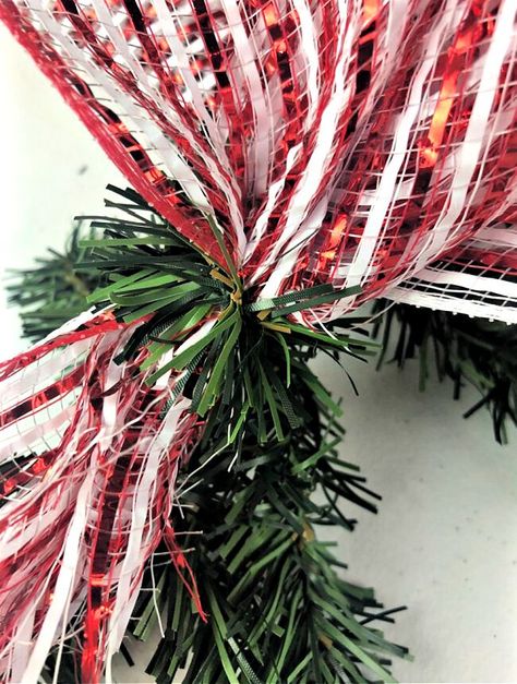 Check out this quick candy theme Christmas garland idea you can make for cheap. Decorate your front porch for Christmas with this easy diy idea. Candy Theme Christmas, Outdoor Christmas Garland, Porch Garland, Mesh Garland, Deco Mesh Garland, Outdoor Garland, How To Make Garland, Diy Christmas Garland, Inexpensive Christmas