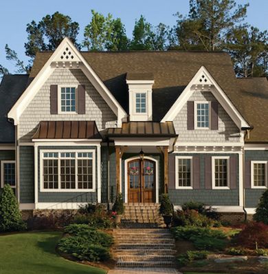 When it comes to picking exterior paint colors, there are a number of things to consider before making a final decision. Here are some basic do’s and don’ts to help you choose the perfect color—or colors—for your dream home. Grey House White Trim, Dark Blue Houses, House Paint Color Combination, Brown Roof, Gray House, Grey House, Exterior House Paint Color Combinations, Exterior House Color, Siding Colors