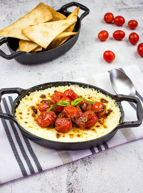 baked ricotta dip with parmesan and tomatoes in a black dish Baked Ricotta Dip, Ricotta Dip Recipes, Leftover Ricotta, Tomato Appetizer Recipes, Parmesan Tomatoes, Beach Recipes, Ricotta Dip, Cheesy Crackers, Ricotta Cheese Recipes