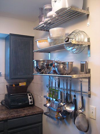 Kitchen organization: IKEA functional storage for lids, hanging big utensils and pans... completed 2012. originally had these racks for storage and to hang pots. found a baker's rack instead, placed a single bar under the top shelf for hanging frequently used pots. Cocina Diy, Small Kitchen Organization, Small Kitchen Storage, Diy Small, Tiny Kitchen, Hanging Pots, Trendy Kitchen, Storage Design, Pots And Pans