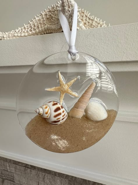 Beautiful acrylic disk ornaments. Many styles to pick from with real sand, starfish, shells and resin. Decorated with ribbons to hang. Ready to ship. Size is 4" The colour may vary due to lighting. This listing is for 1 ornament. Please be aware resin is a challenging substance to work with as it is very unpredictable. These pieces are handmade and may have micro bubbles and slight imperfections.  If you are not completly satisfied with your purchase, please dont hesitate to contact me. My goal Resin Beach Ornaments, Resin Shell Art, Resin Ornaments Diy, Disk Ornaments, Sand Starfish, Ocean Ornaments, Resin Ocean Art, Nautical Christmas Ornaments, Nautical Ornaments