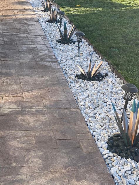 Grass Rock Border, Inground Pool Landscaping Ideas Rock Waterfall, White Rock Border Landscaping, River Rock Around Patio, Sidewalk With Rocks, Driveway Lined With Rocks, Rock Bed Plants, Succulent Backyard Ideas, Rocks Lining Driveway