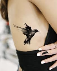 Crow And Books Tattoo, Raven Tatoos Woman, Tattoo Ideas Raven, Raven Hand Tattoo, Crow Tattoo For Women, Raven Wings Tattoo, Black Raven Tattoo, The Raven Tattoo, A Bird Tattoo