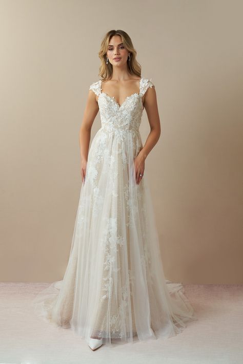 Moonstone is our bridal gown that embodies an ethereal and romantic look. She features a V-neckline with illusion tulle cap sleeves embellished with floral lace applique, that trails down to the A-line skirt with a hint of sparkle. We designed this with a low illusion V-back and a chapel length train for added drama as you walk down the aisle. Chapel Train Wedding Dress, Short Sleeve Wedding Dress, Wedding Dress Cap Sleeves, Wedding Dress Flowy, White Champagne, Pretty Wedding Dresses, Floral Wedding Dress, Wedding Dress Lace, Cute Wedding Dress