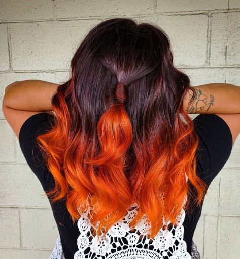 Hair colorist, Bre Ellis (@breellisofficial), painted a bright orange shade on the dark mane's ends, creating an eye-catching autumn hair. Wants this? Visit our website for more dark ombre styles! #darkombrehair #darkombrehaircolor Hair Color Ideas For Brunettes Orange, Dark Hair With Orange Underneath, Orange Ends Hair, Balayage Hair Vivids, Orange Balayage Hair Dark Brown, Dark Red Hair With Orange Highlights, Black To Orange Ombre Hair, Brown To Orange Hair, Brown To Orange Ombre