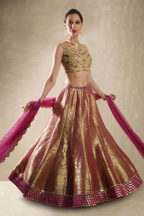 This Set Features A Pomegranate Benarasi Lehenga Set. A Kalidar Benarasi Lehenga Embellished With Mirror Belt And Border Is Teamed With The Classic Renee Label Mirror Work Blouse. The Sheer Net Blouse Is Embellished With Dori, Mirrors, & Beads With Sequin Sheathed Bustier. A Net Dupatta With Mirror Buttis & Scallop Border Completes The Look. Cancan & Pockets Are Included. Mirror Belt, Brocade Lehenga, Banarasi Lehenga, Net Blouse, Net Skirt, Mirror Work Blouse, Organza Lehenga, Scallop Border, Net Blouses