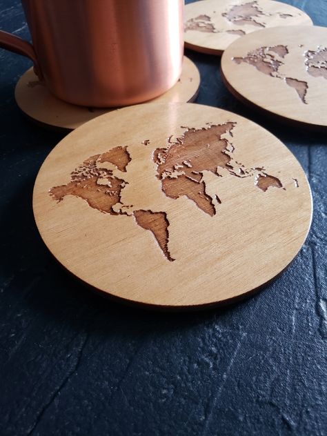 "Love to travel? Know someone who loves to travel? Then these world map coasters are perfect for you! These come in a set of four and have been waterproofed to ensure durability. Each coaster has four felt pads on the bottom to prevent scratches.  Size: 4\"x4\"x1/4\" Material: Birch wood" Coaster Engraving Ideas, Coaster Wood Burning, Laser Cut Coasters, Glowforge Projects Ideas, Market Day Ideas, Laser Cut Coaster, Glowforge Projects, Map Coasters, Engraving Projects