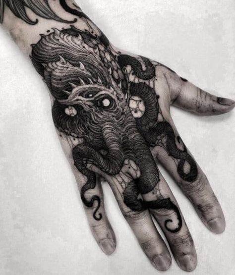 20 of the most potent hand tattoos for men you’ll ever see! - Body Artifact Ominous Tattoos, Kraken Hand Tattoo, Hand Palm Tattoos, Cthulhu Tattoo, Hand Tattoos For Men, Traditional Hand Tattoo, Fox Tattoo Design, Skull Hand Tattoo, Knuckle Tattoos