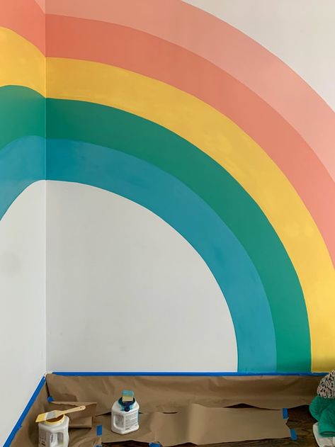 Here’s How I Created a Spectacular $50 Rainbow Mural in My Daughter’s Room | Cubby Playroom Ideas Rainbow, Simple Playroom Mural, How To Draw A Rainbow On A Wall, Corner Rainbow Mural, Hand Painted Rainbow On Wall, Diy Wall Rainbow, Rainbow Nursery Wall Art, Rainbow Mural Bedroom, Rainbow Wall Design