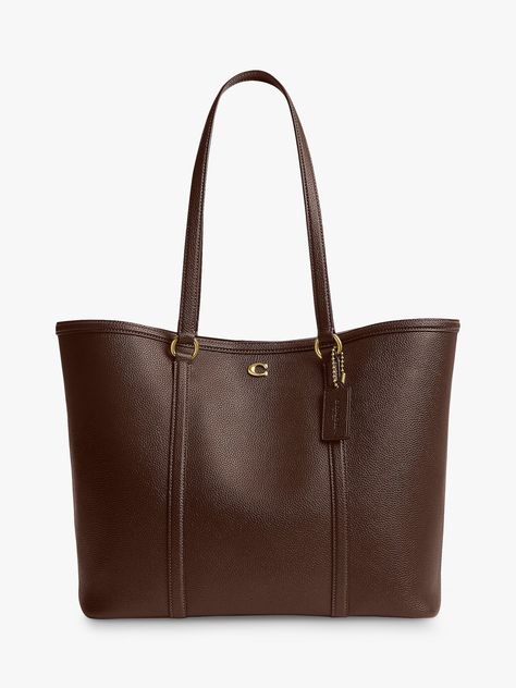 The classic tote reimagined for the new season, pick this trusty piece from Coach. Whipped up from smooth and dreamy leather that's made to last, it fastens with a magnet. Uni Bags Handbags, Coach Bag Brown, Coach Brown Tote Bag, It Bags 2024, Brown Purse Aesthetic, Uni Bag Aesthetic, Leather Tote Bag Aesthetic, Cute Bags Aesthetic, Bags For Uni