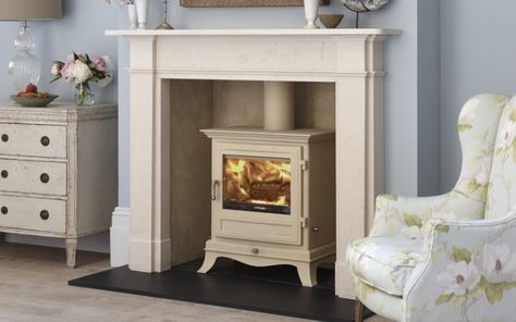 The Beaumont 6KW stove has swept cabriole legs and a corniced top section. It will set you back £1,375 (excluding vat). It sits in the Devonshire fireplace. Both from Chesneys (chesneys.co.uk) White Stove Fireplace, White Log Burner Fireplace, Cream Stove Fireplace Ideas, White Log Burner, Real Log Burner Living Room, Cream Woodburner, Gas Stove Fireplace Cream, Marble Fire Surround With Log Burner, Victorian Fire Surround With Log Burner