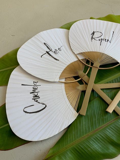 **Please message me to purchase, steps below. I will create a custom listing for you. Do not purchase this listing.** Guide guests to their seats and keep them cool during your party with personalized paper hand fans. Your guests' names will be brush lettered on each fan, or choose to have all the fans lettered with the bride and groom's initials or first names and wedding date. Additional options include: first name of graduate + year, or a short celebratory phrase like "Surprise!" or "Happy 40 Tropical Wedding Favor, Paper Hand Fans, Calligraphy Place Cards, Tropical Wedding Theme, Tropical Wedding Decor, Fiji Wedding, Tropical Wedding Inspiration, Wedding Tropical, Jamaica Wedding