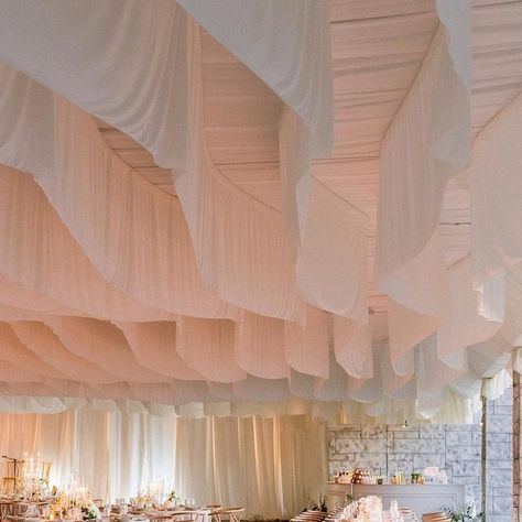 by josiah carr + justin mcgregor on Instagram: "- D I N N E R T I M E - Over 200 guests were welcomed into the tent for @connarfranklin and @aaroncarpenter ‘s wedding at @biltmoreestate . There were dozens of panels of ivory draping that danced overhead in the breeze, the sun was setting over the mountains in the distance, and hundreds of candles illuminated the reception space. We worked with @snif.co for our client to select their favorite candle scent, and there were Snif candles on the table Indoor Wedding Drapery, Tent Ceiling Draping, Draping Wedding Reception, Wedding Tent Draping, Ceiling Draping Wedding, Overhead Decor, Wedding Scent, Ceiling Wedding, Candle Ceiling