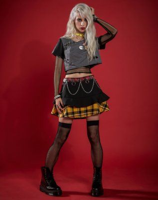 Are you ready to rock? You'll look like a punk rock princess as soon as you slip into this rocker chick costume on Halloween night! The adorable layered skirt featurea a plaid detail that will add instant color to your dark look. The mesh undershirt and distressed crop top will have you looking like you just left your world tour! Get ready for a night of head-banging and punk rock! Includes: Cropped shirt Long sleeve mesh shirt Skirt 5 buttons Choker Fishnet thigh highs Long sleeves and short sl Punk Rock Women Outfits, Punk Rock Costume Women, Rock Halloween Costumes Women, Rock Costume Women, Punk Rock Halloween Costumes, Punk Rock Costume, Mesh Undershirt, Punk Fashion Women, Punk Rock Women