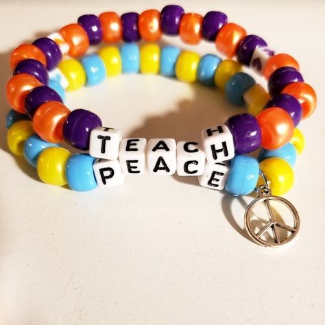 Adorable And Positive "Teach Peace" Double Strand Kandi Bracelet With A Peace Charm. Great For Music Festivals An Raves Bracelet Is 30 Beads Around Made With Jump Ring, White Letter Beads, Pony Beads, Elastic String Please See Photo For Size Comparison Of Charm Tags: Edc, Edm, Rave, Festival, Kandi, Plur, Kawaii, Kandi Bracelet, Single Kandi Bracelet, Peace, Beaded Bracelet, Word Bracelet, Peace Charm Bracelet, Letter Bead Bracelet, Kandi Raver, Beaded Charm Bracelet, Bracelet Set, Peace Kandi Bracelet, Rave Gear, Teach Peace