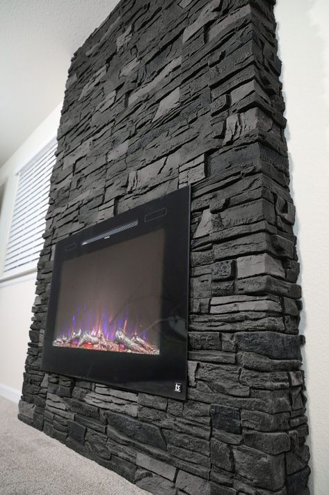 Black Rock Fireplace Stones, Black Stone Fireplace Ideas, Black Rock Fireplace, Genstone Faux Stone, Lava Rock Fireplace, Faux Stone Fireplaces, Stone Electric Fireplace, Grey Stone Fireplace, Rock Fireplace