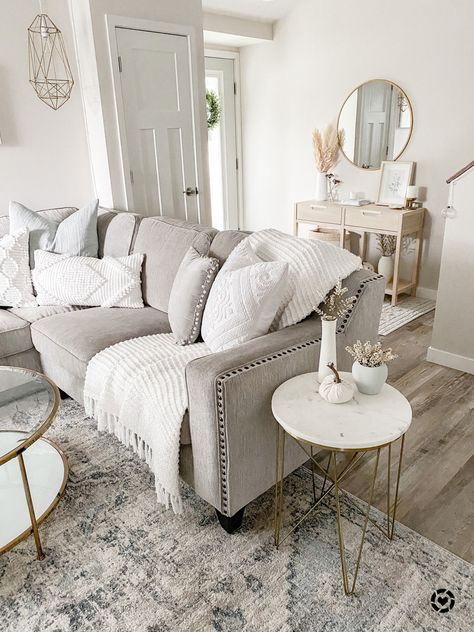 Neutral living room, grey corner sectional with nailhead trim, gold and marble geometric end table, gold and glass coffee table, blue and ivory neutral rug, neutral wooden console table, gold round mirror, entryway decor, entryway furniture, pampas, white vase http://liketk.it/34TUu #liketkit @liketoknow.it #LTKNewYear #StayHomeWithLTK #LTKhome @liketoknow.it.home #affiliate Farmhouse Sectional, Entryway Boho, Textured Pillows, White Living Room Decor, Grey Couch Living Room, Living Room Decor Neutral, Living Room Decor Gray, Beige Living Rooms, Gold Living Room