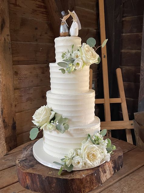 Fresh summery looking wedding cake - 4 tier buttercream frosted with ridged lines and clusters of fresh roses, liaianthus and foliage - couple's own bride & groom geese toppers 4 Tier Buttercream Wedding Cake, Buttercream Rose Wedding Cake, 4 Tier Wedding Cake, Buttercream Roses, Wedding Cake Roses, Buttercream Wedding Cake, Tiered Wedding Cake, Wedding Cake Designs, Sugar Flowers