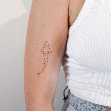 23 Shark Tattoo Ideas and Meanings - 2023 Guide Men’s Shark Tattoo, Cute Shark Tattoos For Women, Small Whale Shark Tattoo, Shark Tooth Tattoo Small, Small Tattoo Line, Small Shark Tattoo Simple, Shark Tattoo On Arm, Dainty Shark Tattoo, Simple Shark Tattoos For Women