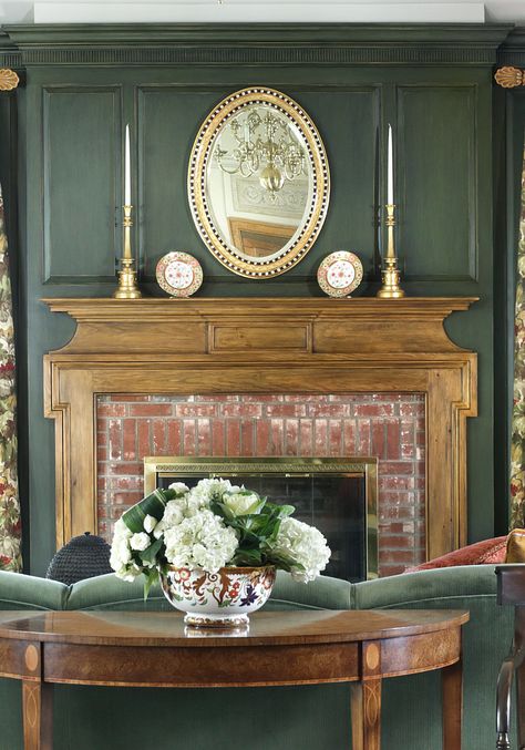 wood fireplace mantel with hunter green wall paneling Brick Fireplace With Green Walls, Wood Paneled Den With Fireplace, Green Wood Wall Paneling, Wood Paneling Over Fireplace, Green Living Room White Fireplace, Grandmillenial Style Fireplace, Hunter Green Fireplace, Sage Green Wood Paneling, Green Wall With Fireplace