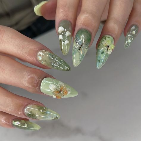 🧚🏻‍♂️ green fairy meadow 🍃 I can’t help but say I slayed this set 💯💚 my top 3 fairycores for sure 🤭 My custom design on a Medium Stiletto @apresnailofficial Gel-X, client asked for fairycore and left everything up to me ✨ #nailinspo #naildesign #vancouvernails #fairycorenails #gardennails #naturenails #nails2inspire #trendynails #gelxinspo #pinterestnails #summernails #springnails #3dflowernails #3dnailart Green Whimsical Nails, Purple And Green Nails Design, Green Fairy Nails, Cottage Core Nails, Green Blue Nails, Fairy Core Nails, Sweetheart Nails, Fairycore Nails, A Person Walking